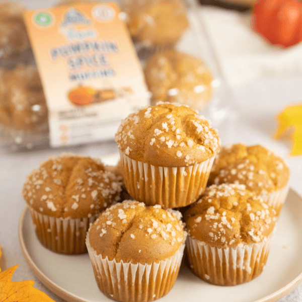 Plate with stack of Farm Boy Vegan Pumpkin Spice Muffins with package of muffins in the background.