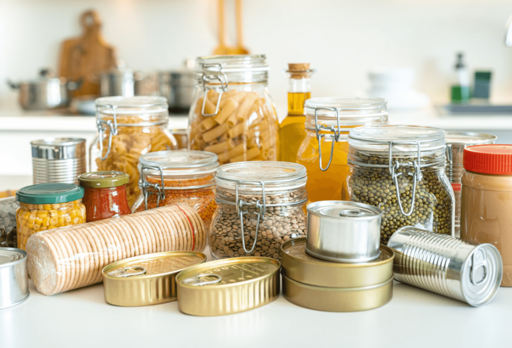 Close up view of six airtight glass jars filled with dried food shot on kitchen counter.