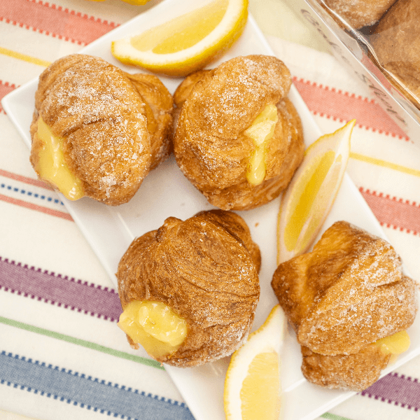 Overhead image of lemon cruffies with lemon wedges