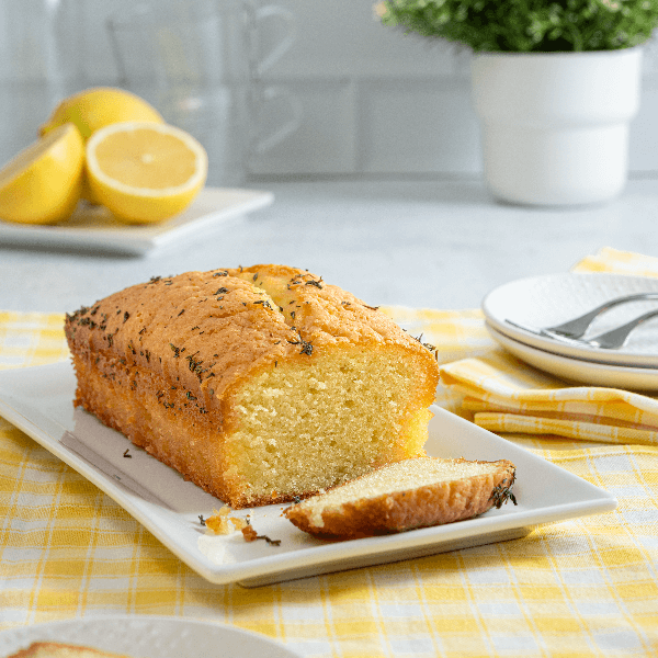 White plate with Farm Boy Lemon Thyme Loaf Cake with slice cut