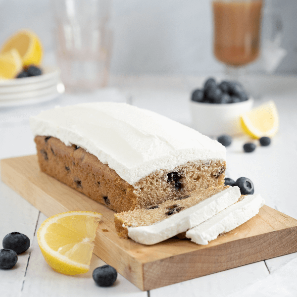 Farm Boy Vegan Blueberry Lemon Loaf Cake with two slices cut on a cutting board