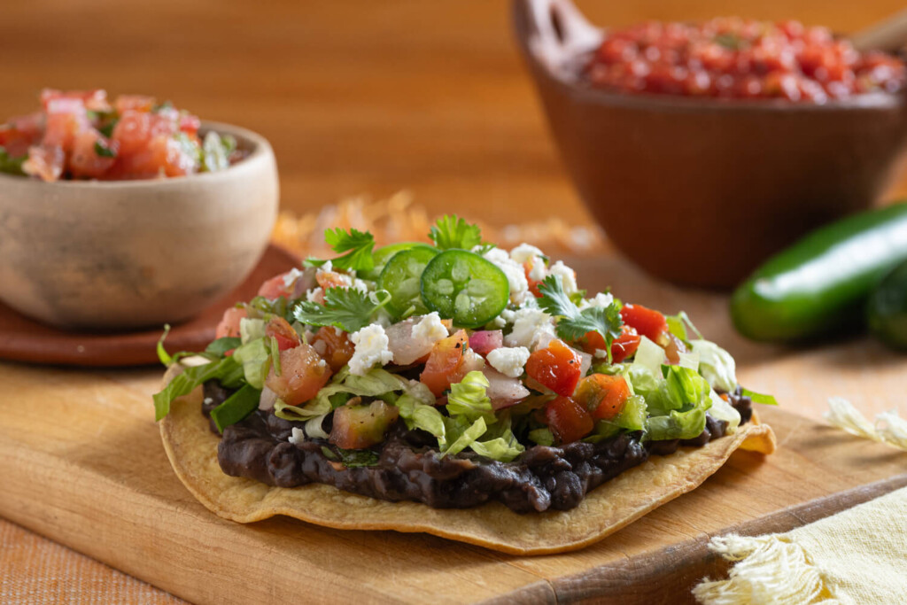 Yellow corn tostada with black beans, pico de gallo, avocado, and cilantro for a healthy recipe