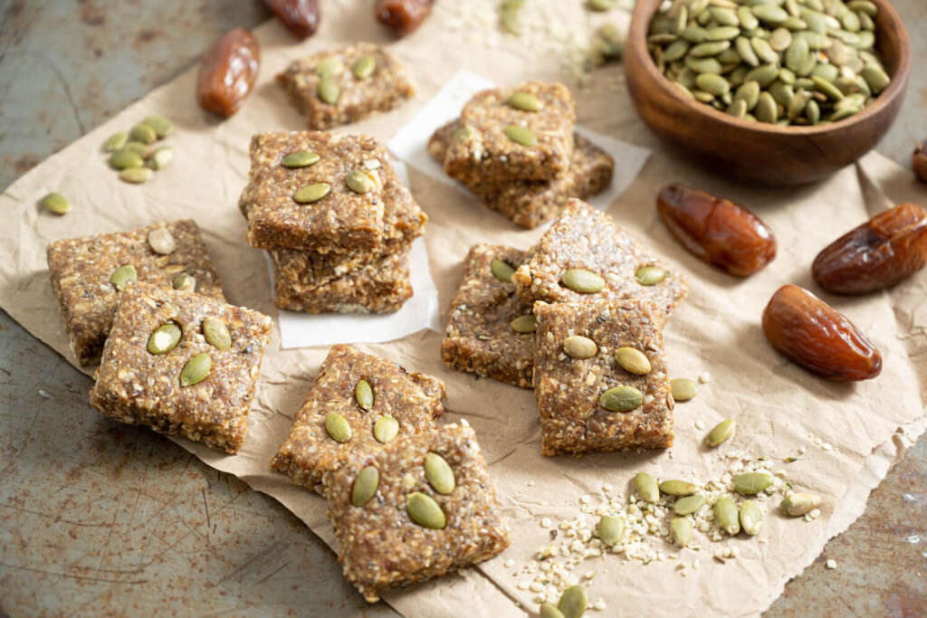 Nutty date energy bars cut into squares as a healthy snack recipe with pumpkin seeds and dates